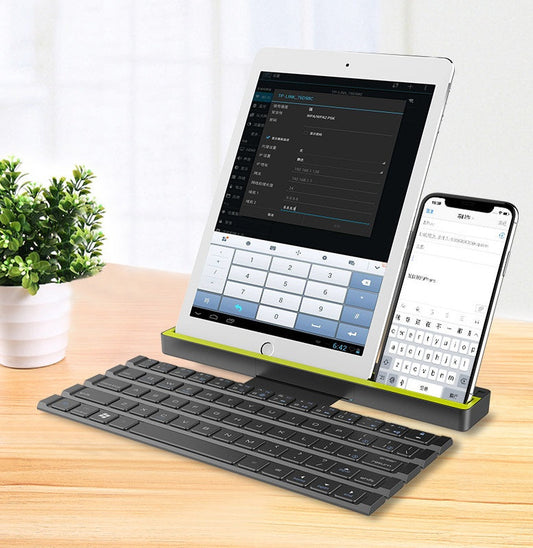 Folding wireless keyboard with retractable cable reel shown in use