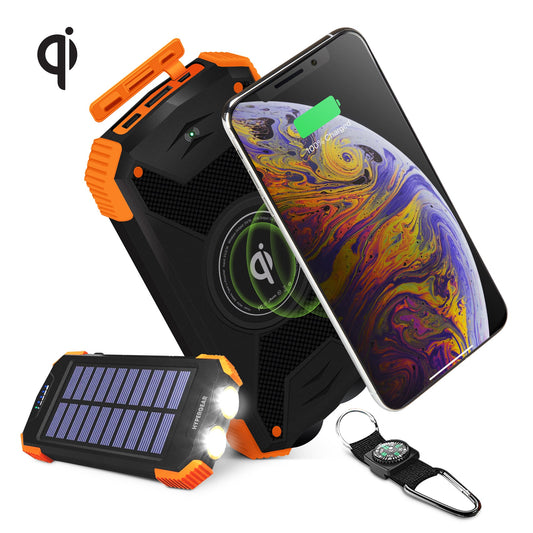 Black HyperGear 10000mAh power bank with its solar panel facing up, next to a charging phone.